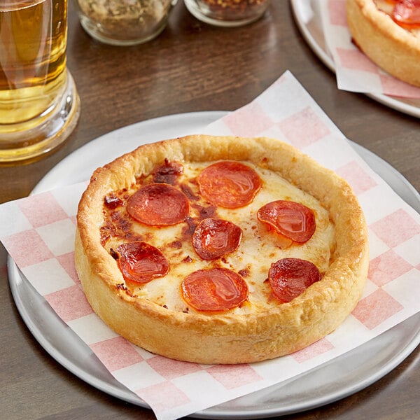 A Pizzeria Uno deep dish pepperoni pizza on a plate.