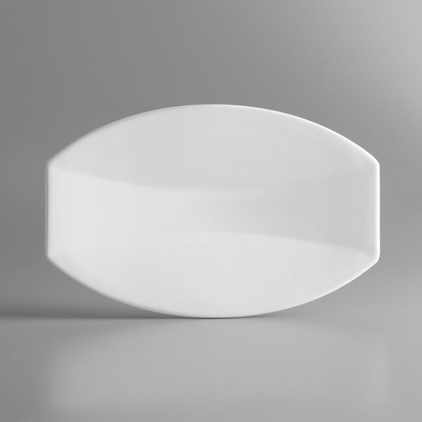 A white oval Vollrath melamine platter on a gray surface.