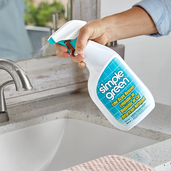 A person spraying Simple Green Lime Scale Remover into a sink.