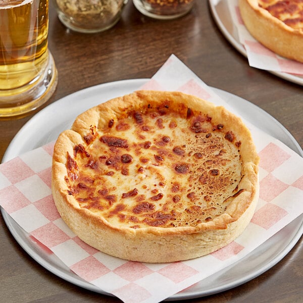 A Pizzeria Uno 7" deep dish cheese pizza on a plate.