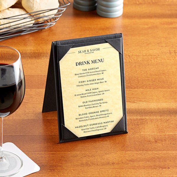 A table set with a menu on gold paper.