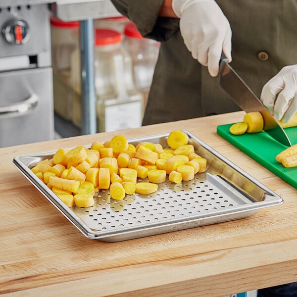 A person cutting a vegetable on a cutting board.