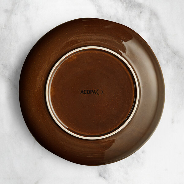 An Acopa Highlands china plate with a brown rim and white center.