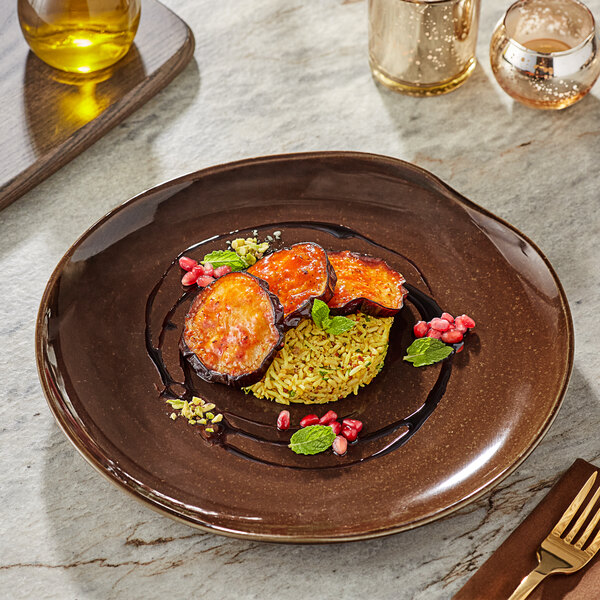 A plate of food with a fork and a spoon on a table.