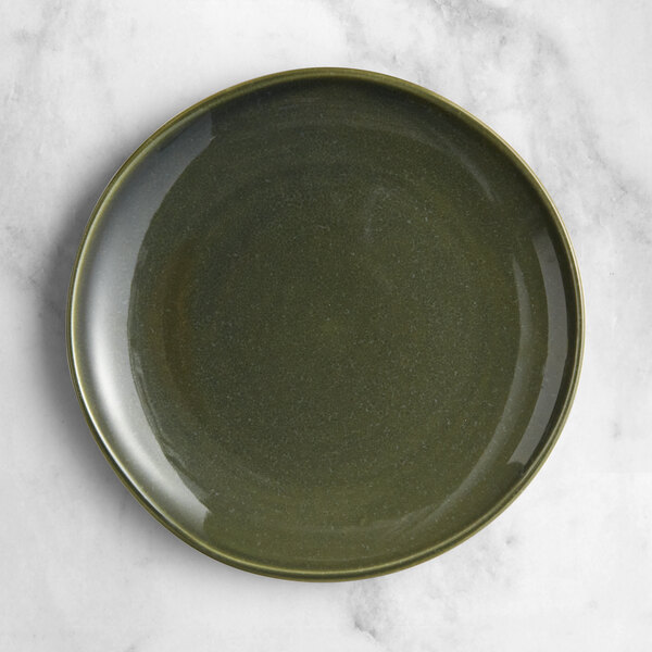An Acopa Highlands juniper green coupe china plate on a marble surface.