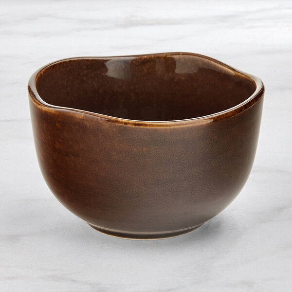 An Acopa Highlands brown china bouillon cup with a handle.