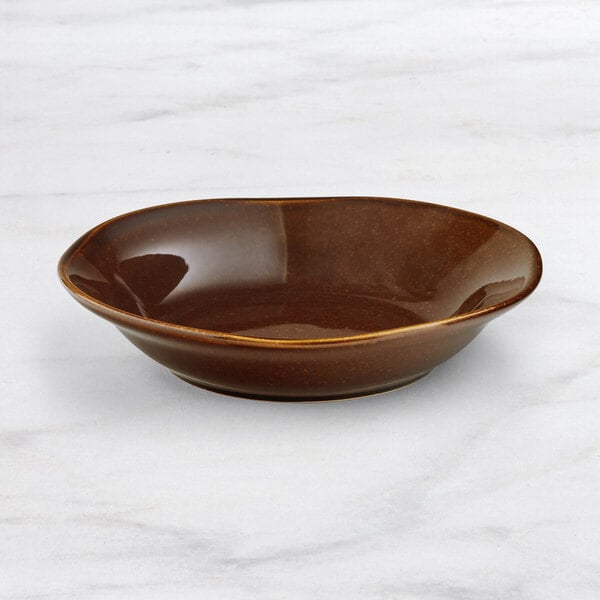 An Acopa Highlands brown china bowl on a marble surface.