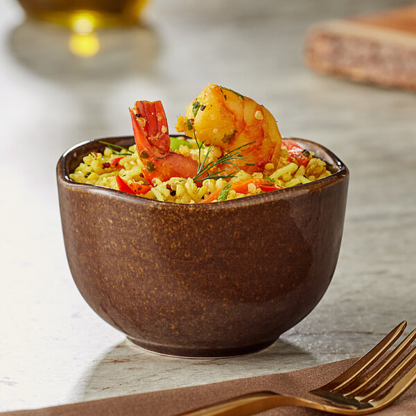 A bowl of rice with shrimp and a fork in an Acopa Highlands hazel bouillon cup.