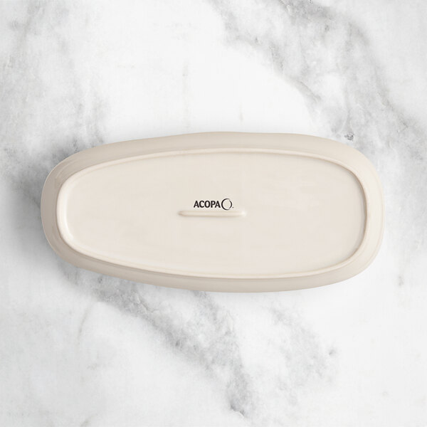 An Acopa Highlands rectangular white birch tray on a marble surface.