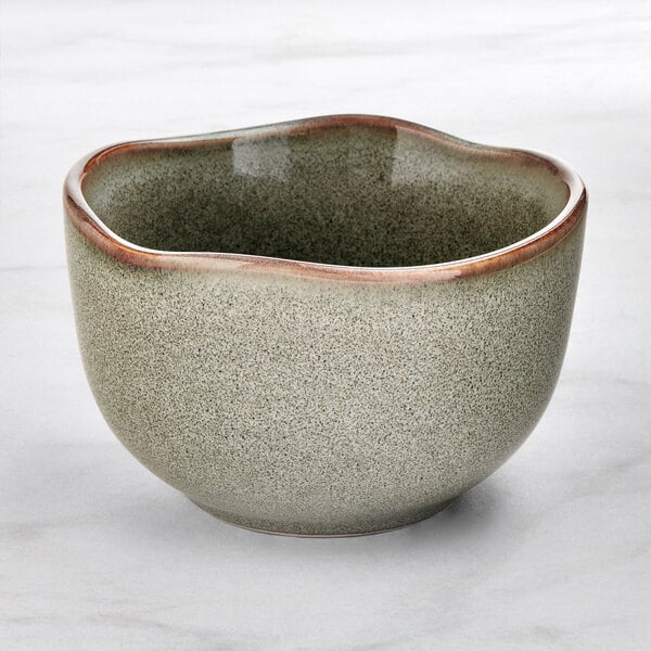 An Acopa Highlands heather gray china bouillon cup with a speckled surface.