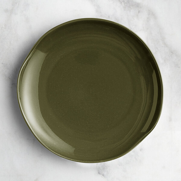 An Acopa Highlands juniper green coupe china plate on a marble surface.