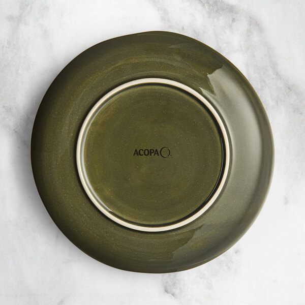 An Acopa Highlands Juniper Green coupe plate with a white rim.