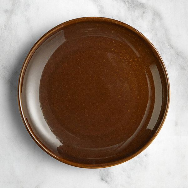 An Acopa Highlands hazel coupe china plate on a marble surface.