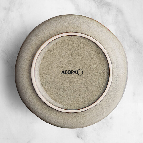 A close up of an Acopa Heather Gray saucer with a white rim.