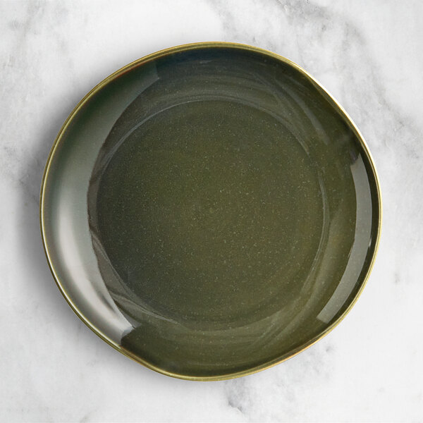 An Acopa Highlands juniper green coupe china plate on a marble surface.