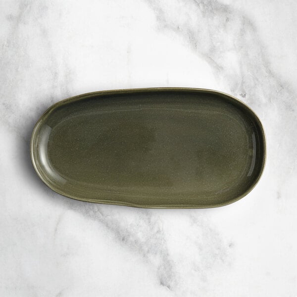 An Acopa Highlands juniper green rectangular coupe china tray on a white surface.