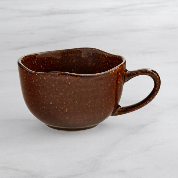 An Acopa Highlands hazel china cup on a marble surface.