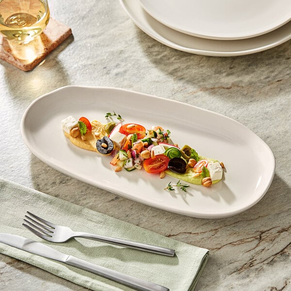 A rectangular white Acopa Highlands china tray with food on it.