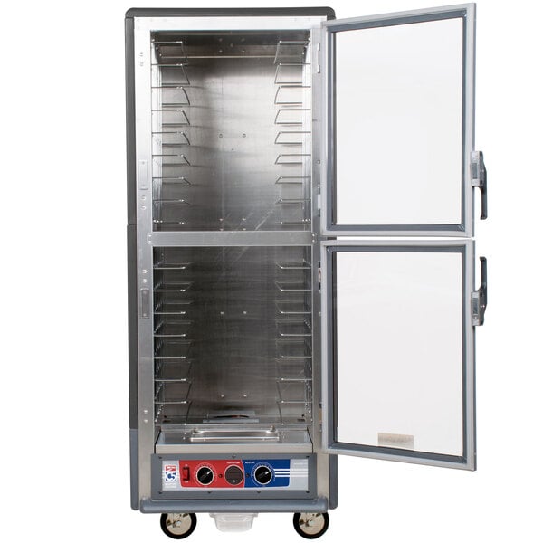 A gray Metro C5 holding and proofing cabinet with clear Dutch doors open.
