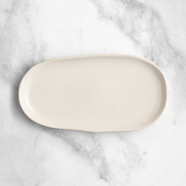 An Acopa Highlands white rectangular china tray on a marble surface.