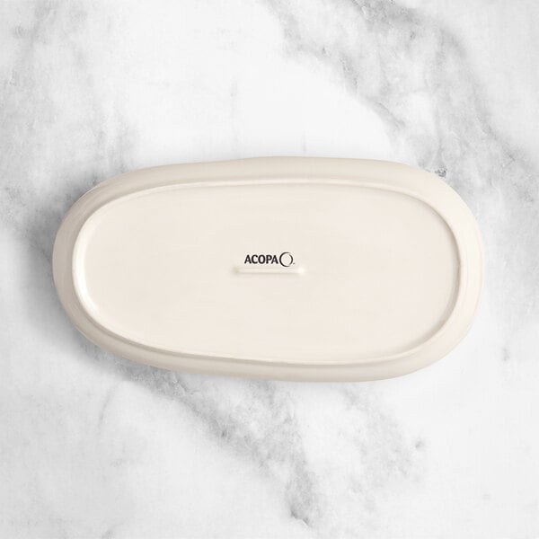 An Acopa Highlands white rectangular China tray on a marble surface.