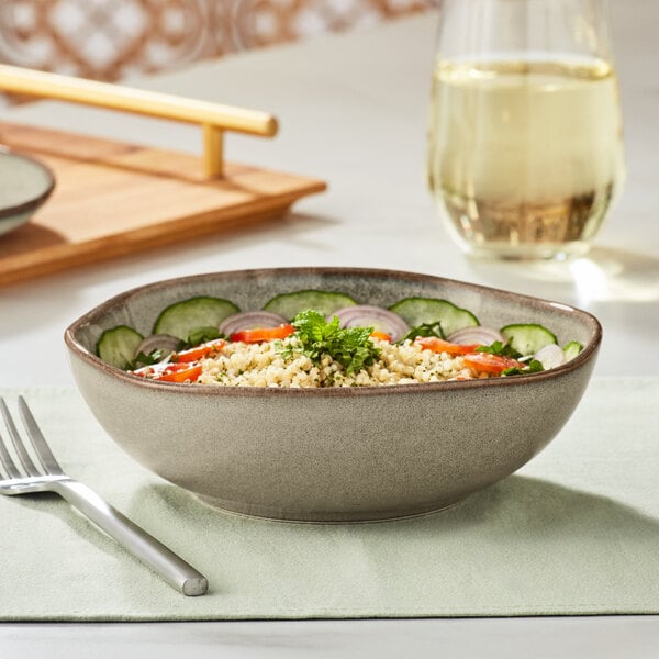 An Acopa Highlands heather gray china bowl filled with food on a table.