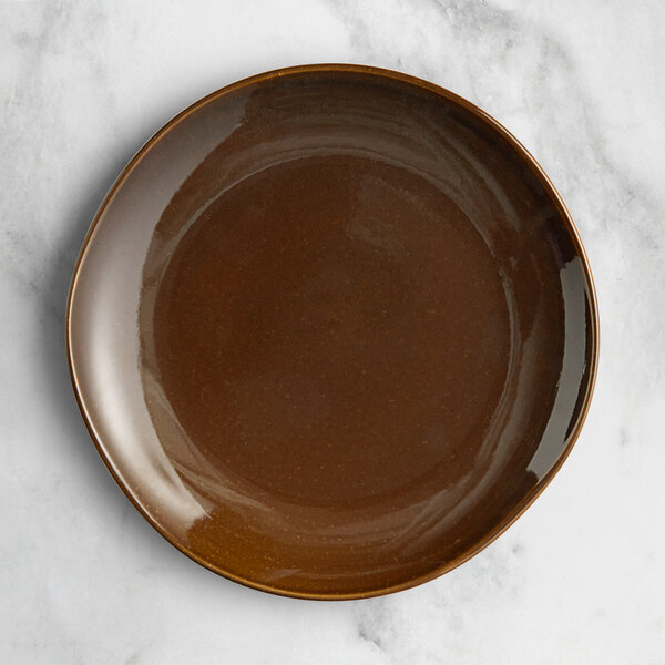 An Acopa Highlands brown china plate on a marble surface.