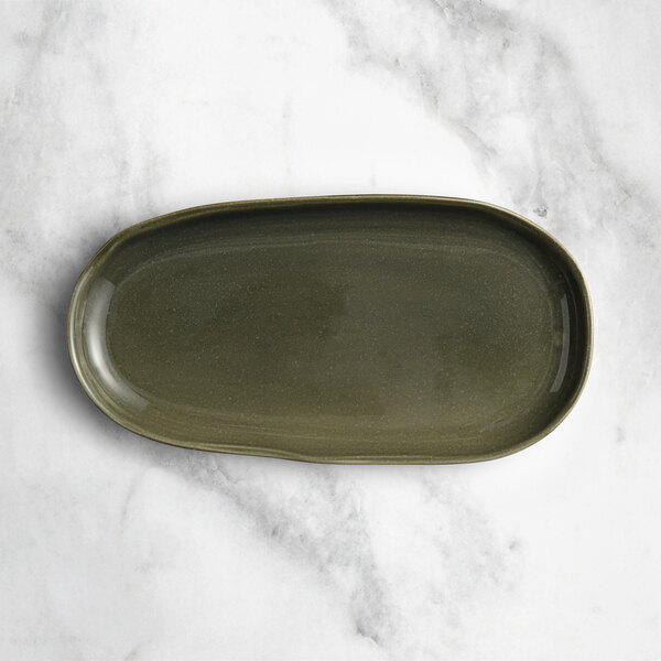 An oval juniper green Acopa Highlands china tray on a white surface.