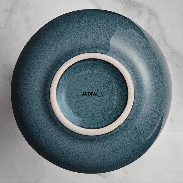 A blue and white ceramic Acopa Highlands sauce cup.