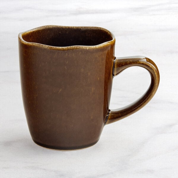 An Acopa Highlands brown china mug with a handle.