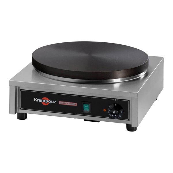 A close-up of a black Krampouz electric crepe maker with a circular edge.