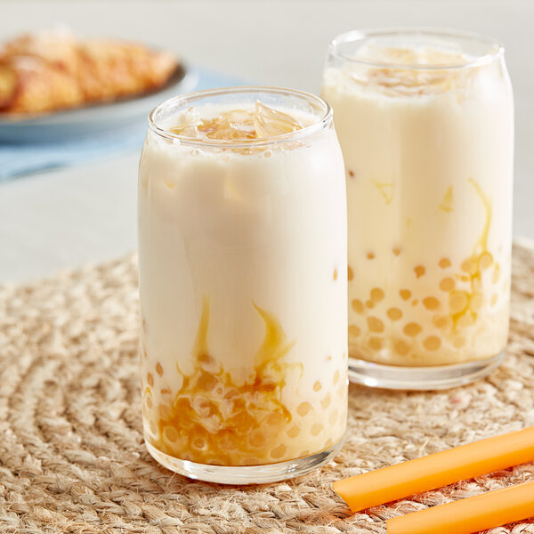 Two glasses of milk with bubbles and  Bossen Creme Brulee bubble tea.