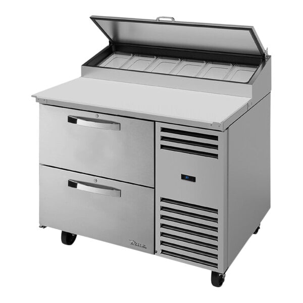 A large silver True refrigerated pizza prep table with two drawers.