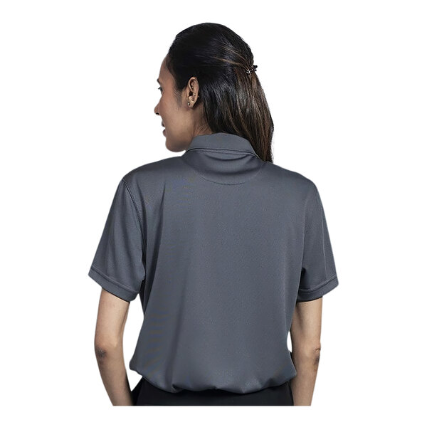 A woman wearing a Uncommon Chef grey short sleeve polo shirt.