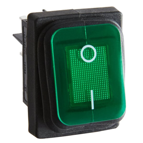 A green push button switch with a white circle.