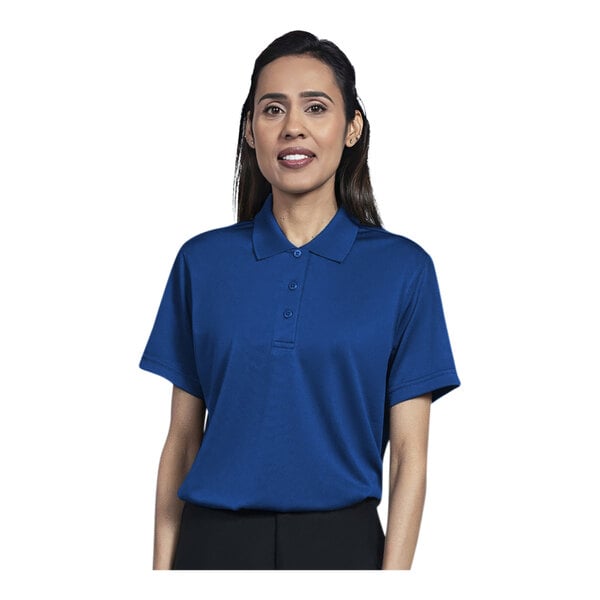 A woman wearing a royal blue short sleeve polo shirt.