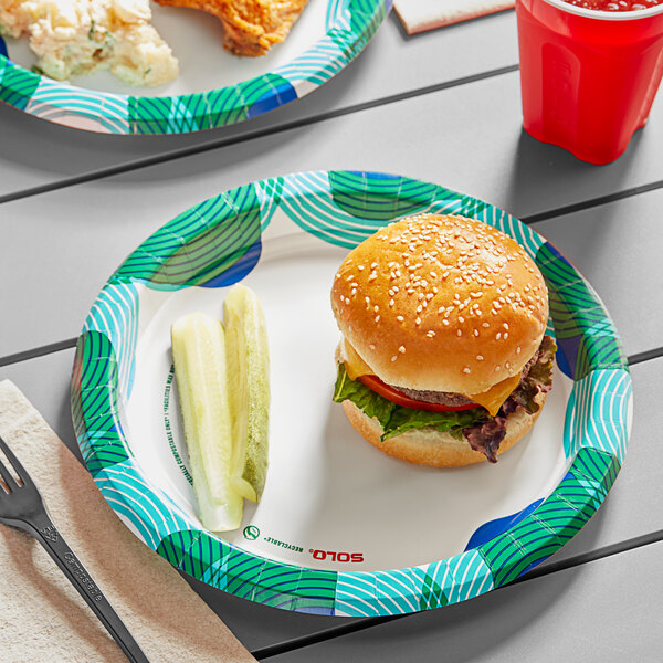 A Solo Bold Hold paper plate with a cheeseburger on it on a table.