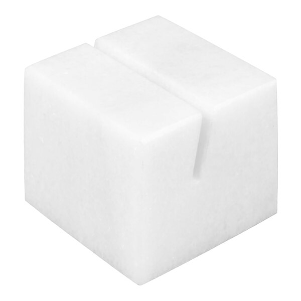 A white, cube-shaped object with a narrow slot on the top surface.