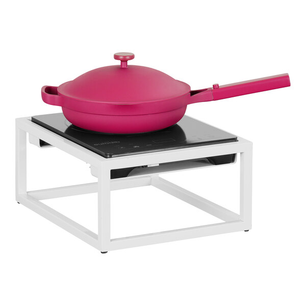 A pink pan with a lid on a white Range Countertop Induction Burner.