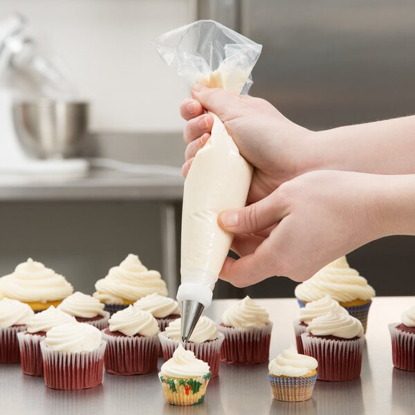 Baker icing cupcakes with a high-grip disposable pastry bag