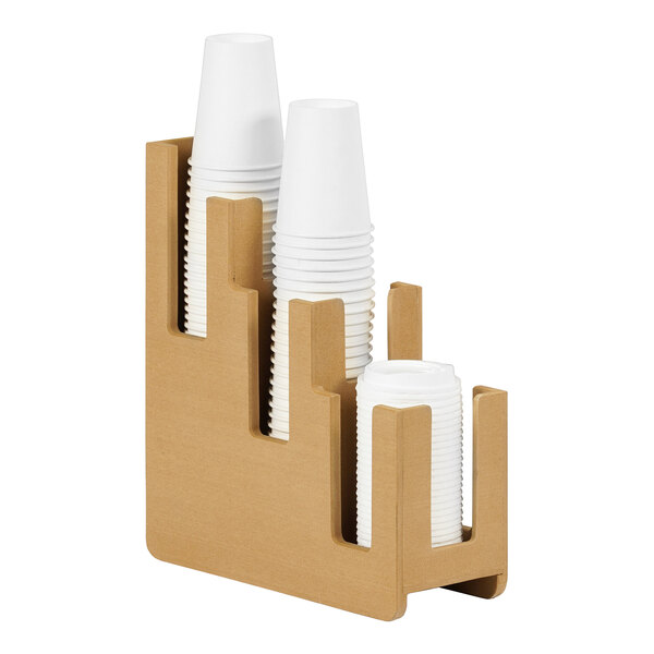 A stack of white paper cups in a wooden holder.