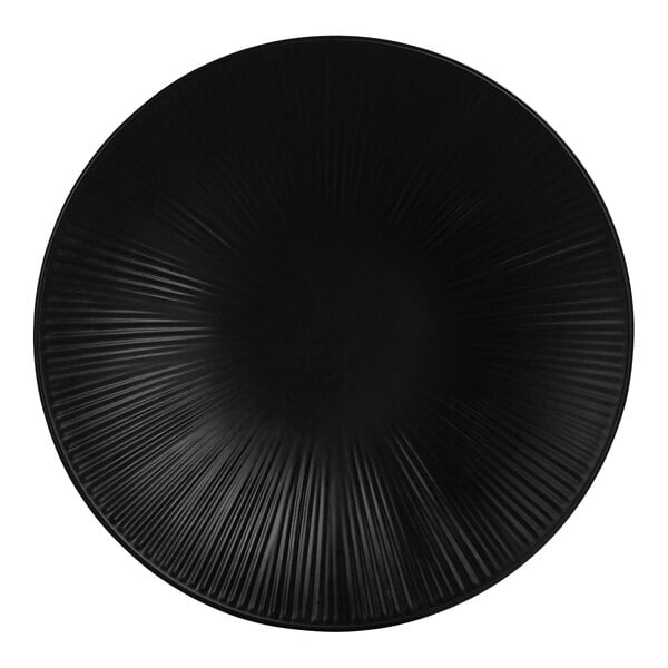 A black Cal-Mil round melamine plate with a circular pattern in white.