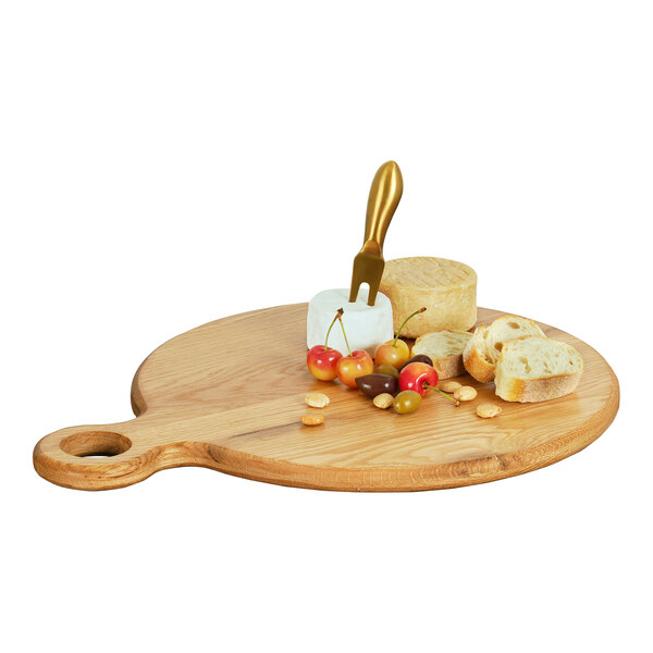 A Cal-Mil oak round serving board with cheese, bread, and fruit.