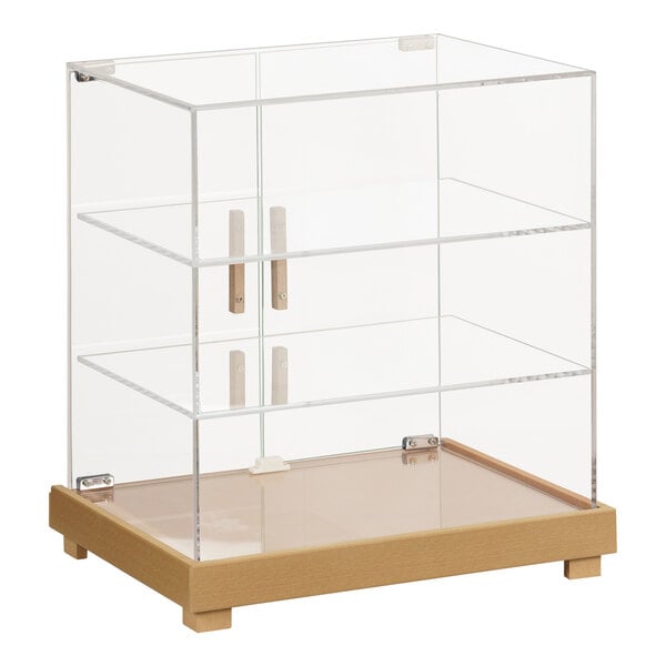 A Cal-Mil clear glass bakery display case with a faux wood base.