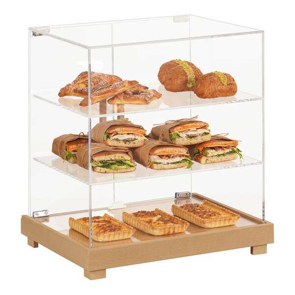 A Cal-Mil bakery display case with food on it.