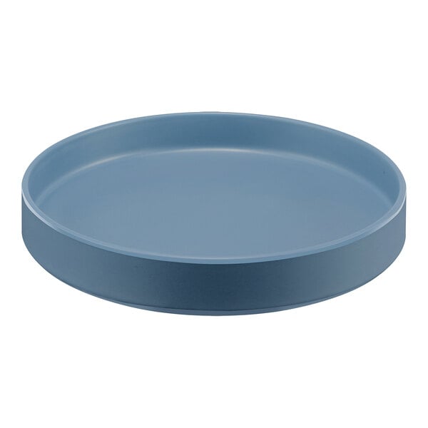 A Cal-Mil stone blue melamine plate with a raised rim on a table.