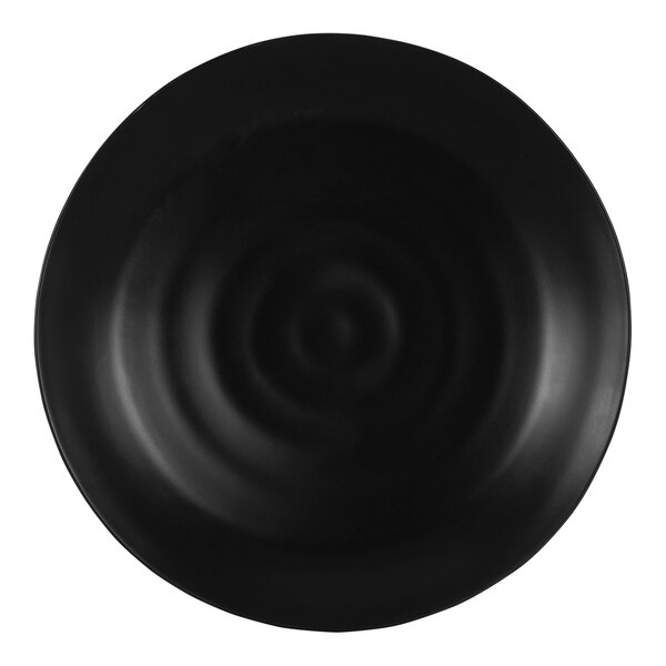 A black round melamine platter with a ripple pattern.