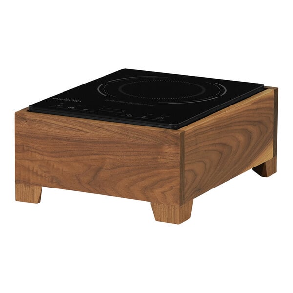 A black RANGE COUNTR induction cooker on a wood countertop.