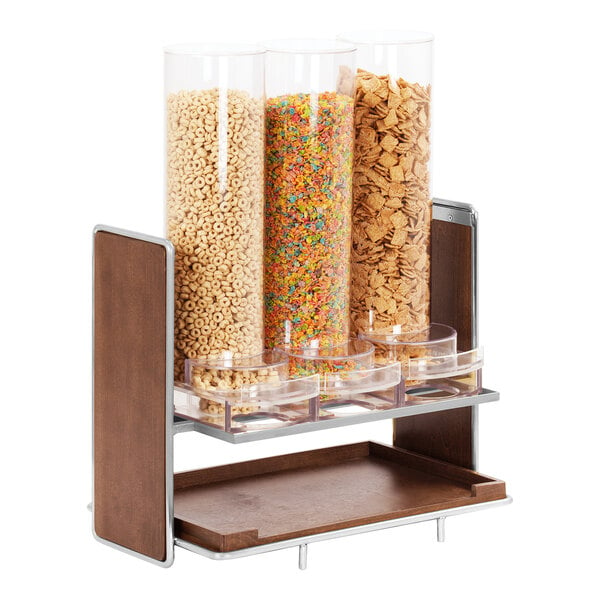 A chrome metal and clear plastic cereal dispenser with three containers of cereal.