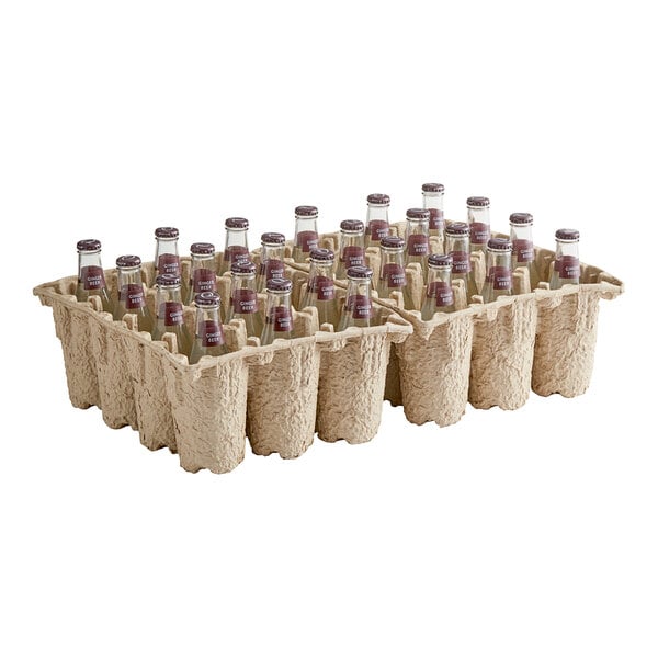 A carton of 24 Q Mixers Premium Ginger Beer bottles with brown caps.
